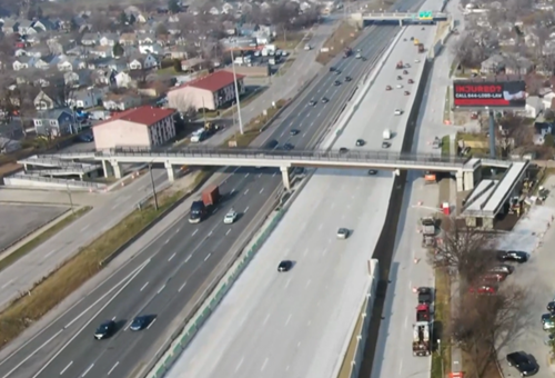 Aerial view of newly rebuilt pedestrian bridge over I-75 freeway and traffic